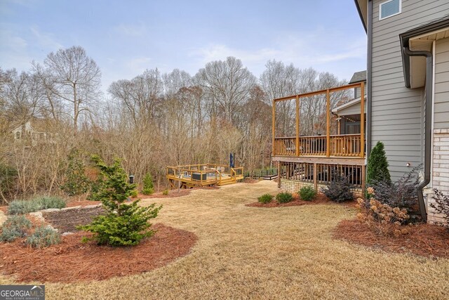 view of yard with a wooden deck