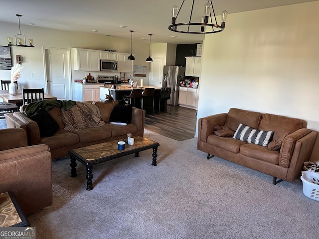 living room with dark hardwood / wood-style flooring and an inviting chandelier