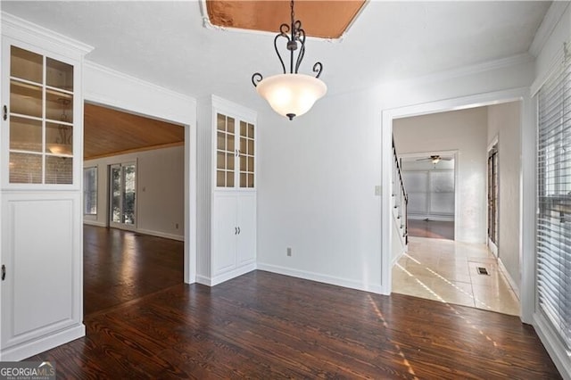 unfurnished dining area featuring crown molding and dark hardwood / wood-style flooring