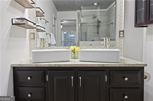 bathroom with ceiling fan, vanity, and a shower with door