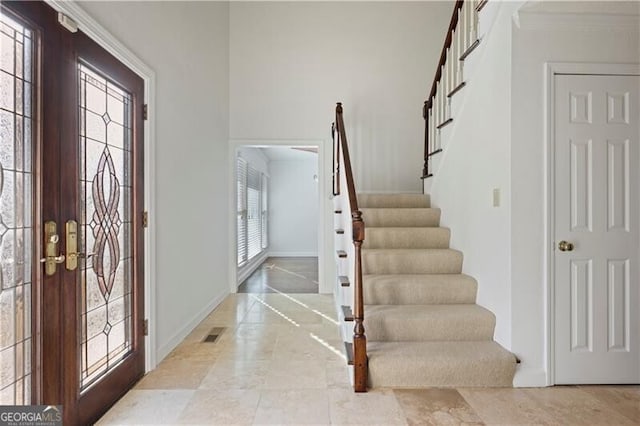 entrance foyer featuring crown molding