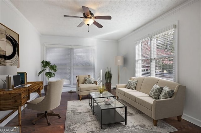 living room featuring ceiling fan, ornamental molding, dark hardwood / wood-style floors, and a textured ceiling