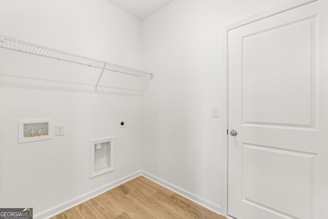 laundry room with washer hookup, electric dryer hookup, and wood-type flooring