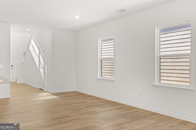 unfurnished room with light wood-type flooring