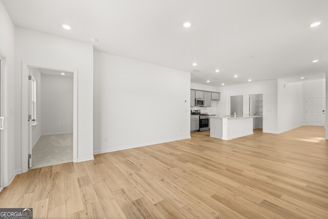 unfurnished living room with light wood-type flooring