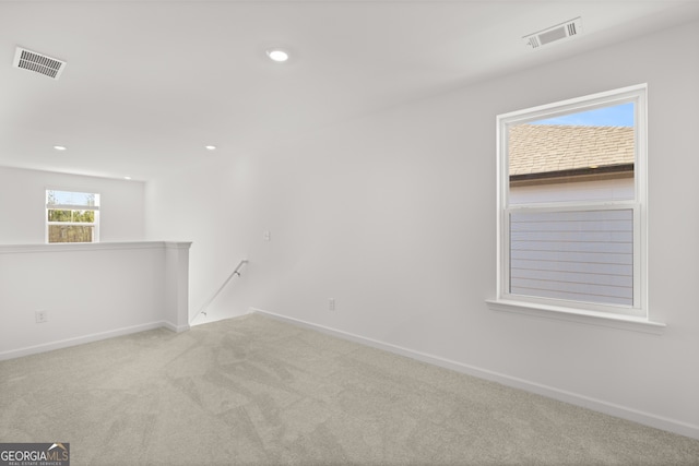 unfurnished room with light colored carpet