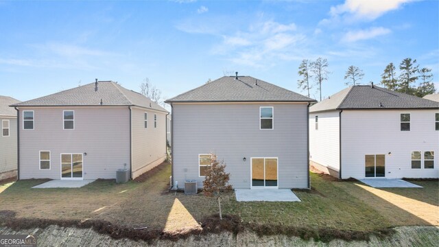 back of house featuring a yard, cooling unit, and a patio