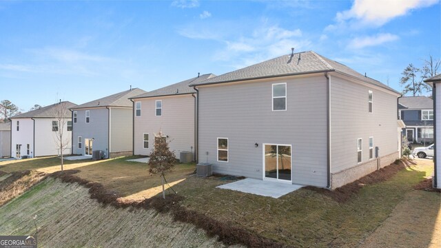 back of house with a lawn, a patio, and central AC