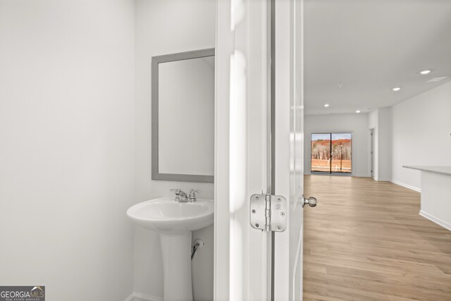 bathroom featuring sink and hardwood / wood-style flooring