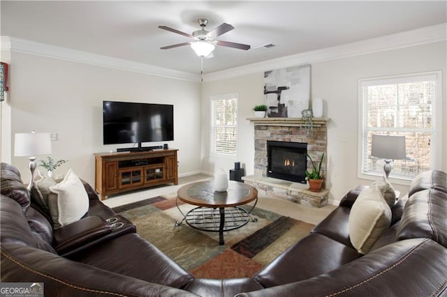 living room with a fireplace, plenty of natural light, and ornamental molding