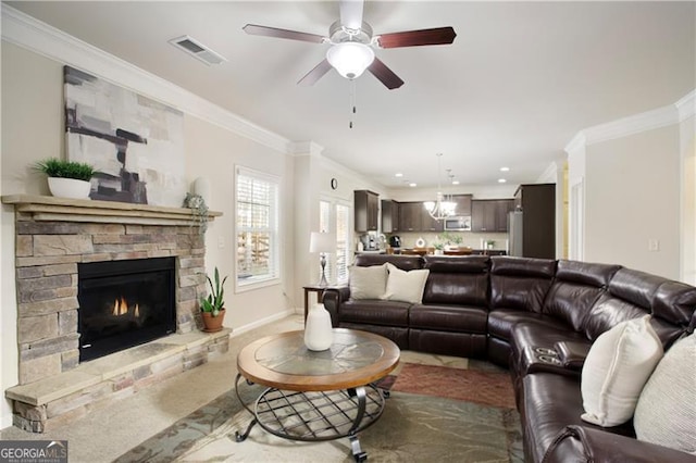 carpeted living room with a fireplace, ceiling fan, and ornamental molding