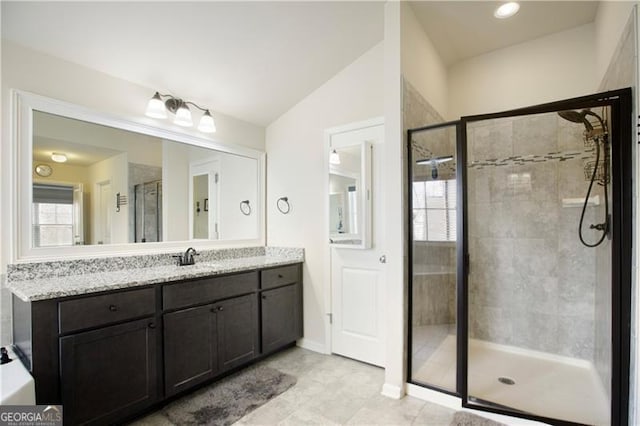 bathroom featuring vanity, an enclosed shower, and lofted ceiling