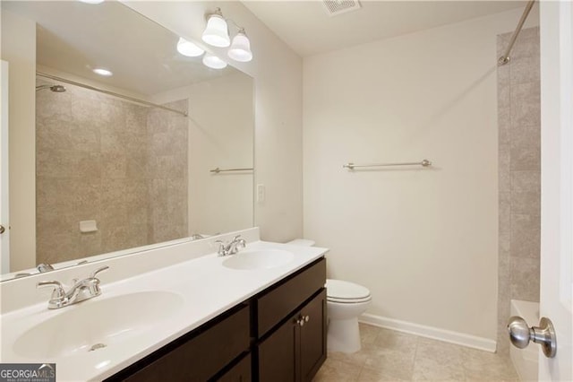 bathroom with tile patterned flooring, vanity, and toilet