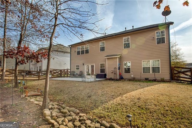 back of property featuring a yard and a patio area