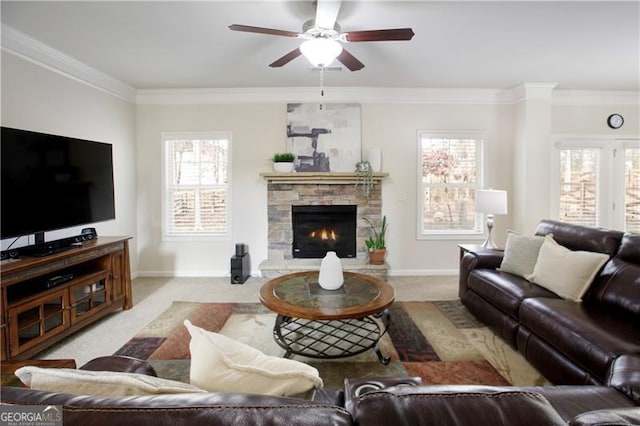 carpeted living room with a fireplace, a wealth of natural light, and crown molding