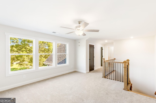 carpeted empty room with ceiling fan