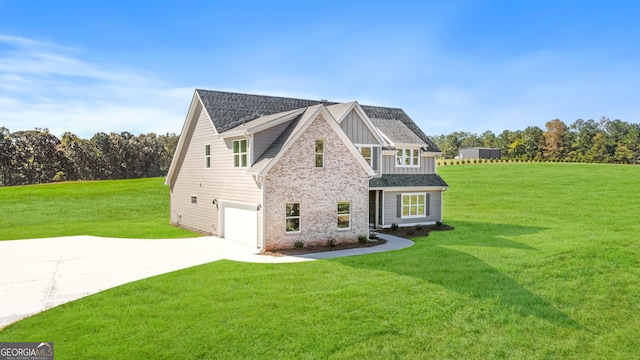 view of front of house featuring a front yard and a garage