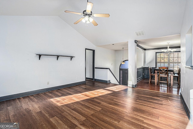 unfurnished living room with ceiling fan with notable chandelier, dark hardwood / wood-style flooring, and high vaulted ceiling