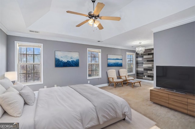 bedroom with a tray ceiling, light carpet, ceiling fan with notable chandelier, and ornamental molding