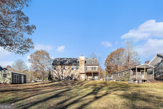 back of property featuring a yard and a storage unit