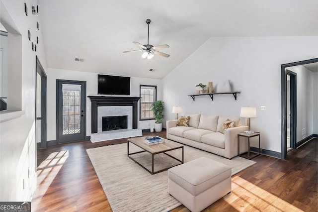 living room with high vaulted ceiling, a brick fireplace, ceiling fan, and dark wood-type flooring