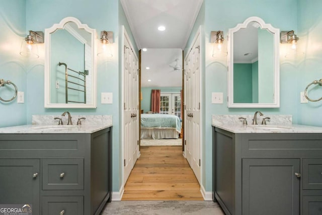 bathroom with vanity, wood-type flooring, and crown molding