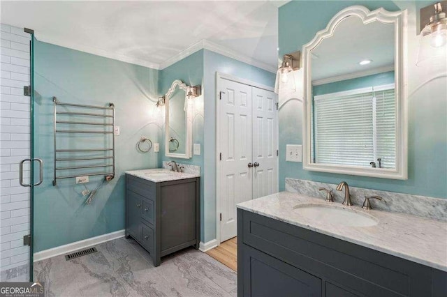 bathroom with a shower with shower door, ornamental molding, and vanity