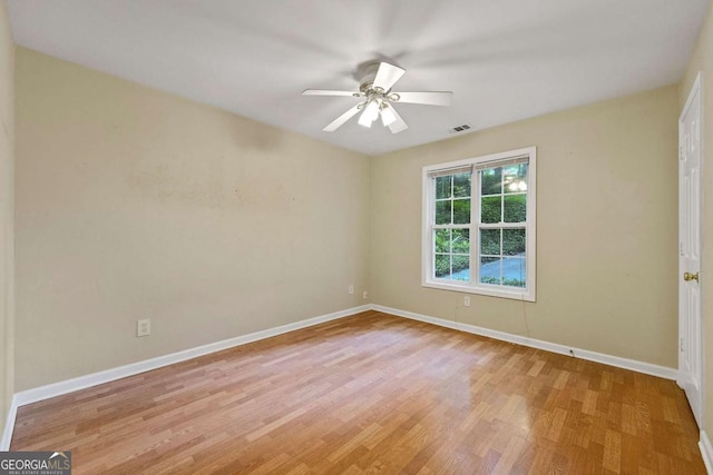 spare room with ceiling fan and light wood-type flooring