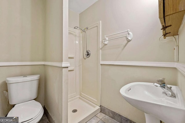 bathroom with tile patterned flooring, a shower, toilet, and sink