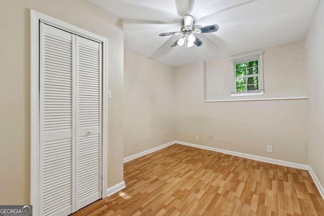 unfurnished bedroom with ceiling fan, a closet, and light hardwood / wood-style floors