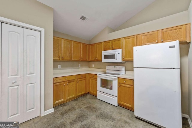 kitchen featuring vaulted ceiling and white appliances