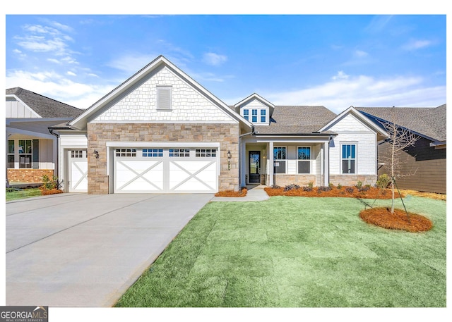 view of front of house with concrete driveway, stone siding, an attached garage, and a front yard