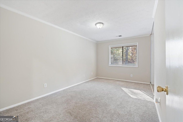 unfurnished room featuring a textured ceiling, carpet floors, and ornamental molding