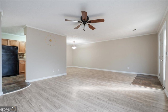 unfurnished living room featuring ceiling fan, light hardwood / wood-style floors, ornamental molding, and a textured ceiling