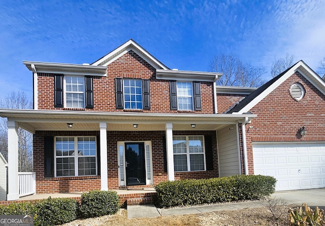 view of front of house with a porch and a garage