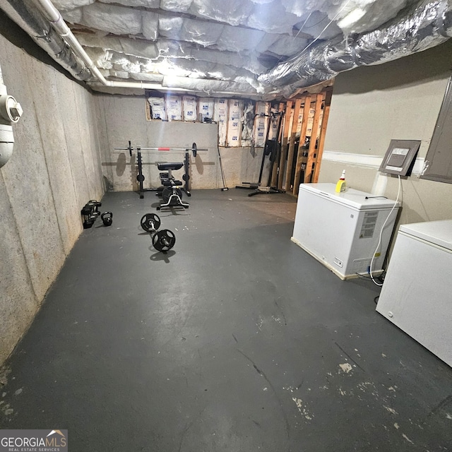 basement featuring refrigerator and washer / clothes dryer