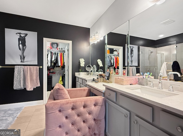 bathroom with tile patterned floors, vanity, and walk in shower