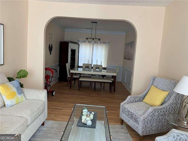 living room with wood-type flooring and crown molding