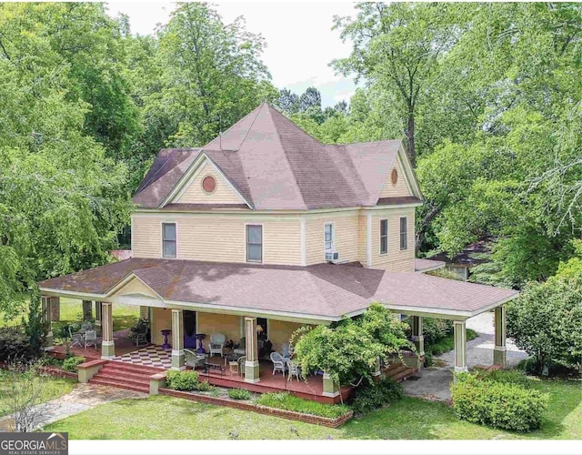 view of front of property with a porch and cooling unit