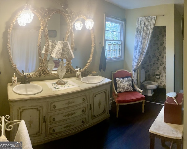 bathroom with hardwood / wood-style flooring, vanity, and toilet