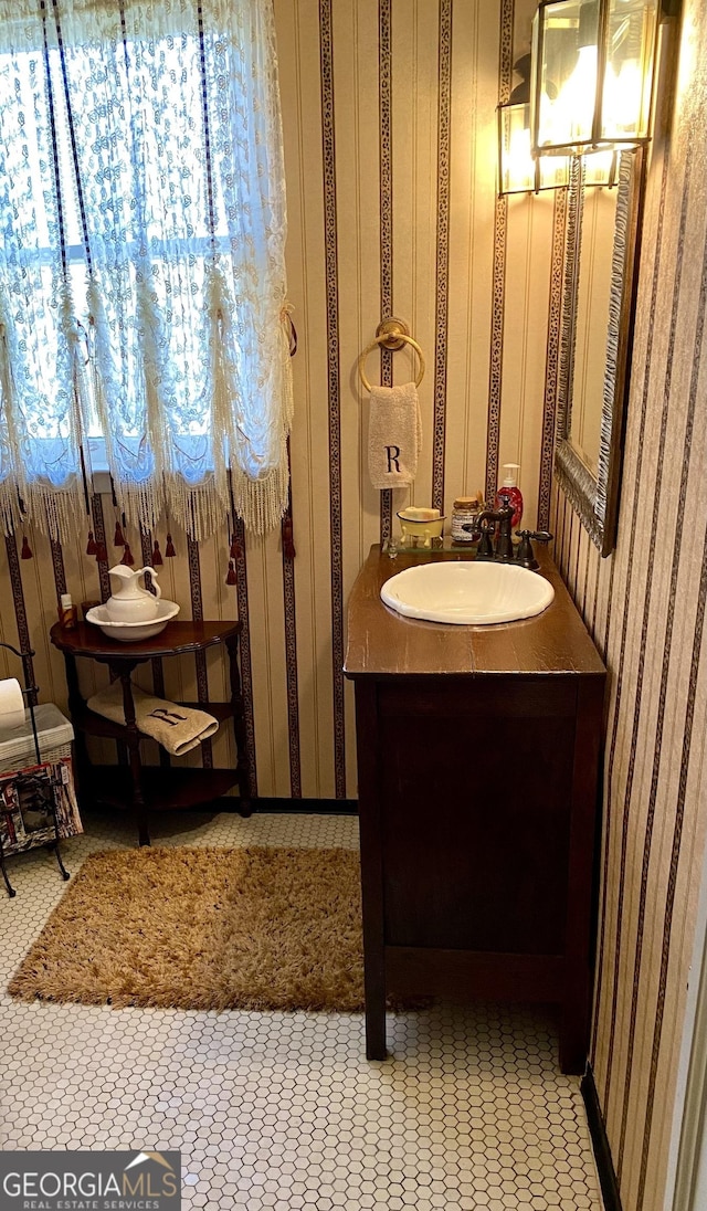 bathroom featuring tile patterned flooring, vanity, and an inviting chandelier