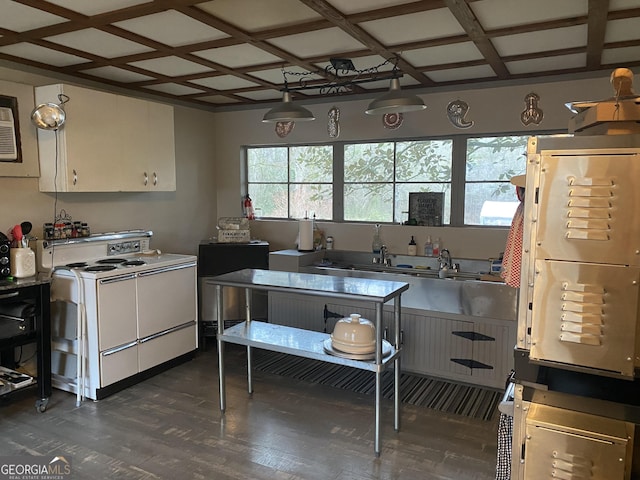 kitchen featuring coffered ceiling, dark hardwood / wood-style floors, decorative light fixtures, white cabinets, and white stove