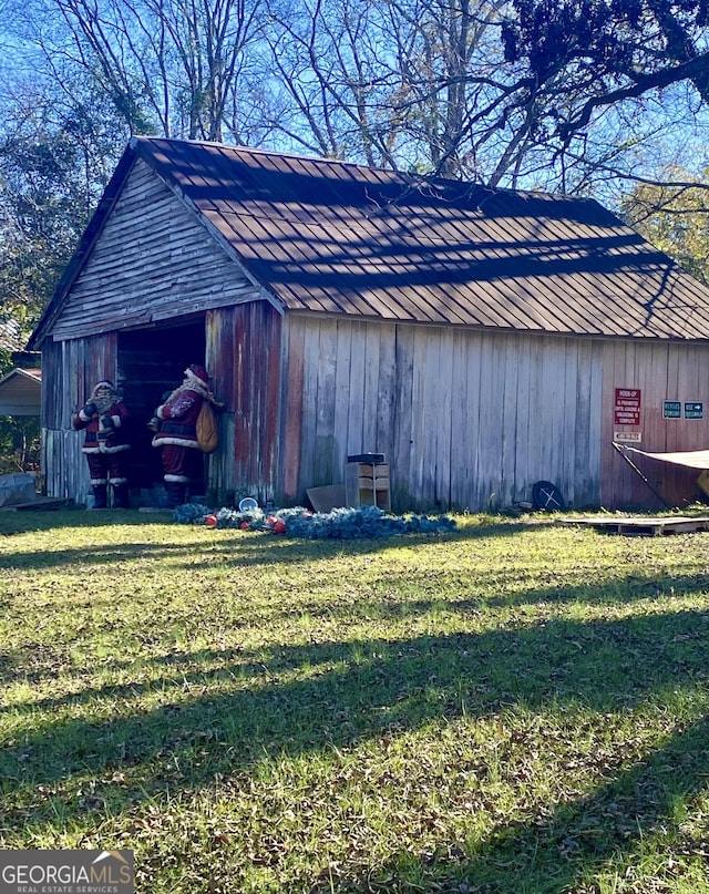 view of outbuilding with a yard