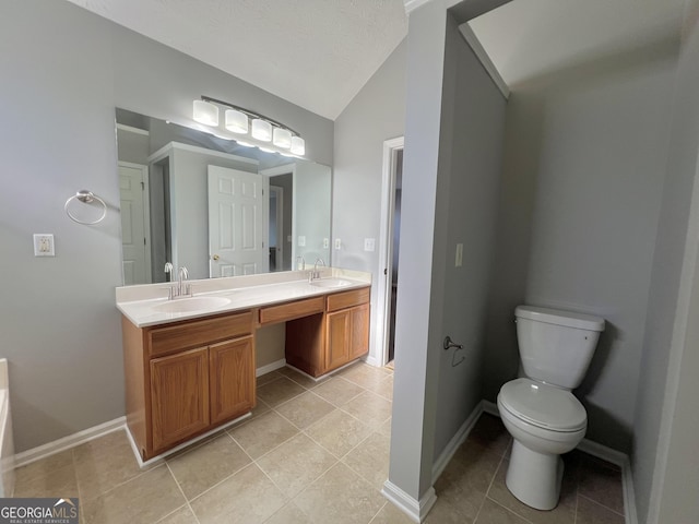 bathroom with tile patterned flooring, vanity, toilet, and lofted ceiling