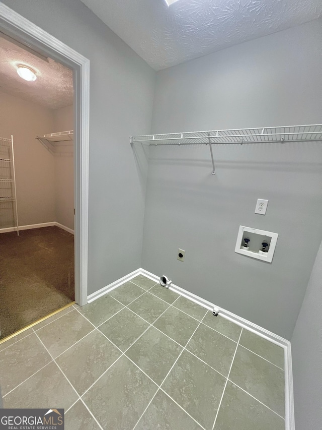 laundry area with hookup for an electric dryer, hookup for a washing machine, carpet flooring, and a textured ceiling