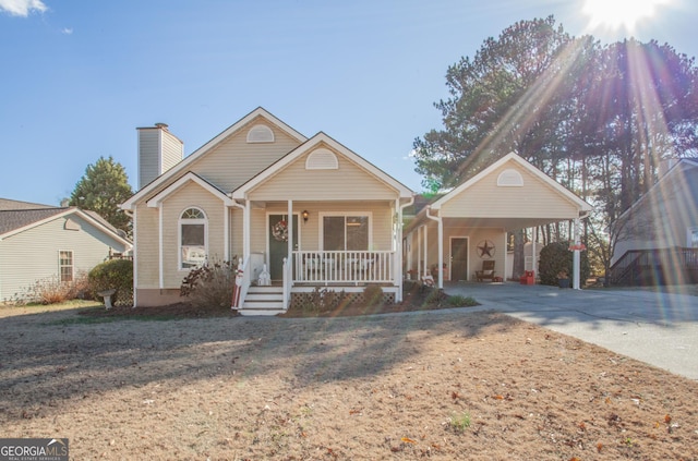 view of front of property with covered porch and a carport