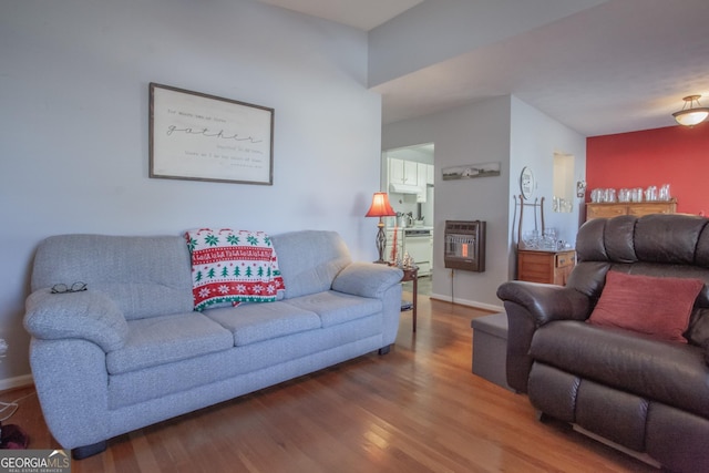 living room with wood-type flooring and heating unit