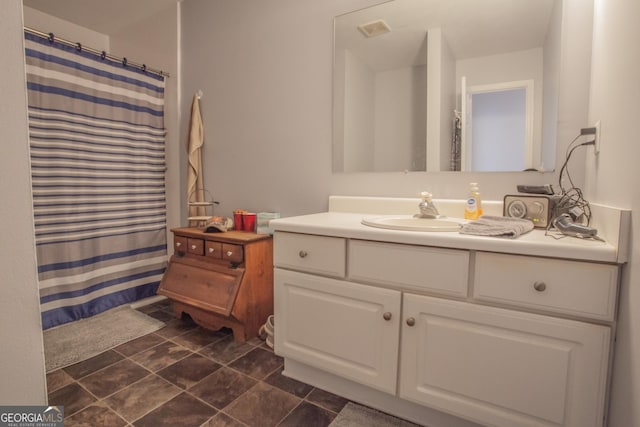 bathroom with a shower with curtain and vanity