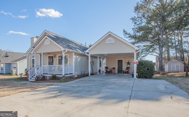 view of front of house with covered porch, a storage unit, and a carport