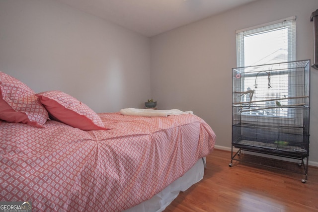 bedroom with hardwood / wood-style floors